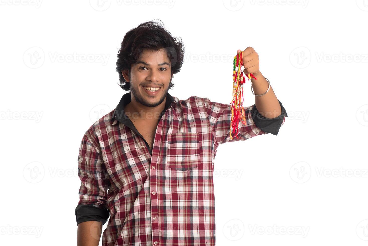 Young men showing rakhi in hand and giving expression on an occasion of Raksha Bandhan festival. photo