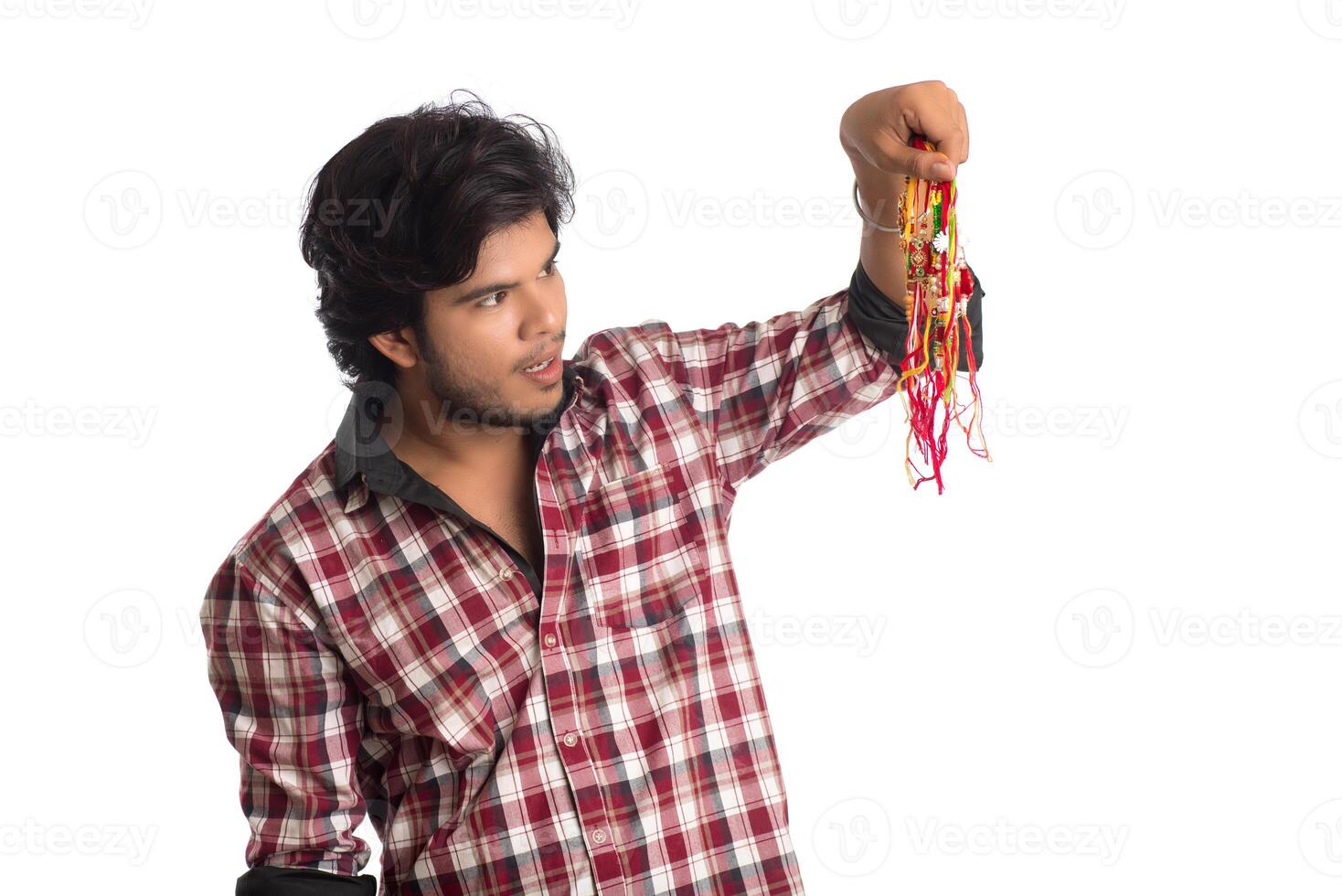 Young men showing rakhi in hand and giving expression on an occasion of Raksha Bandhan festival. photo