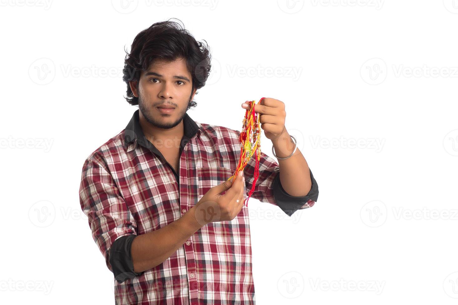 Young men showing rakhi in hand and giving expression on an occasion of Raksha Bandhan festival. photo