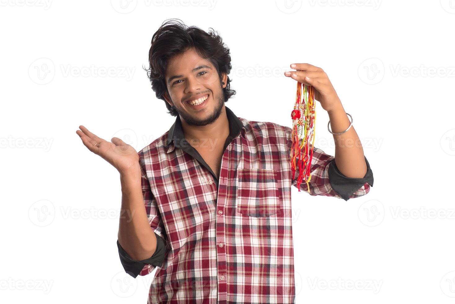 Young men showing rakhi in hand and giving expression on an occasion of Raksha Bandhan festival. photo