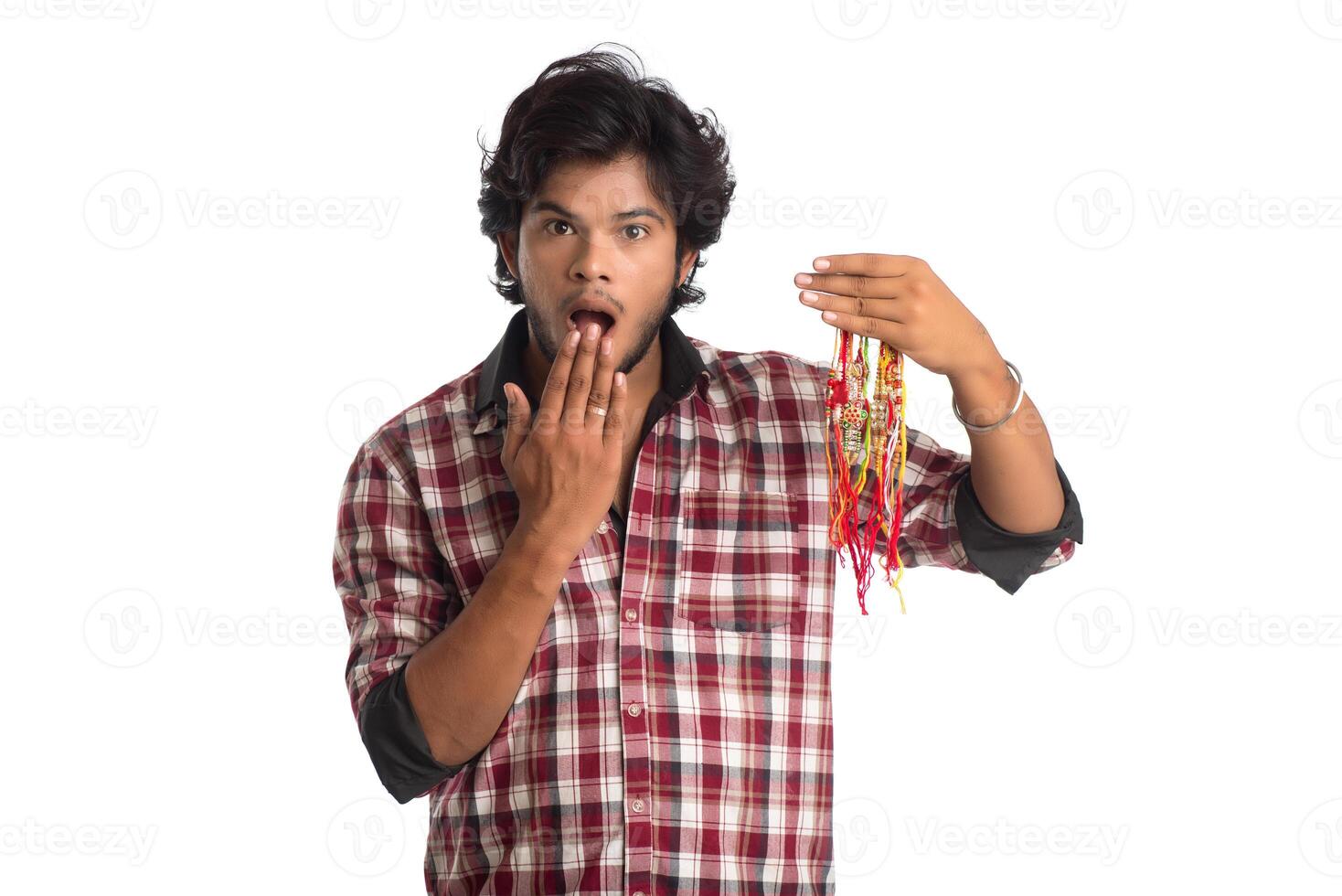 Young men showing rakhi in hand and giving expression on an occasion of Raksha Bandhan festival. photo