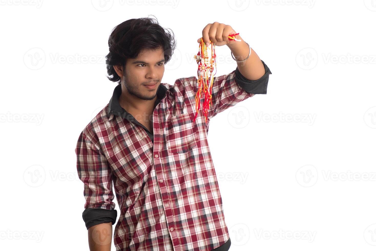 Young men showing rakhi in hand and giving expression on an occasion of Raksha Bandhan festival. photo