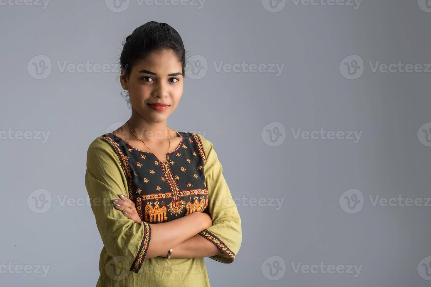 Portrait of beautiful young smiling girl on a grey background. photo