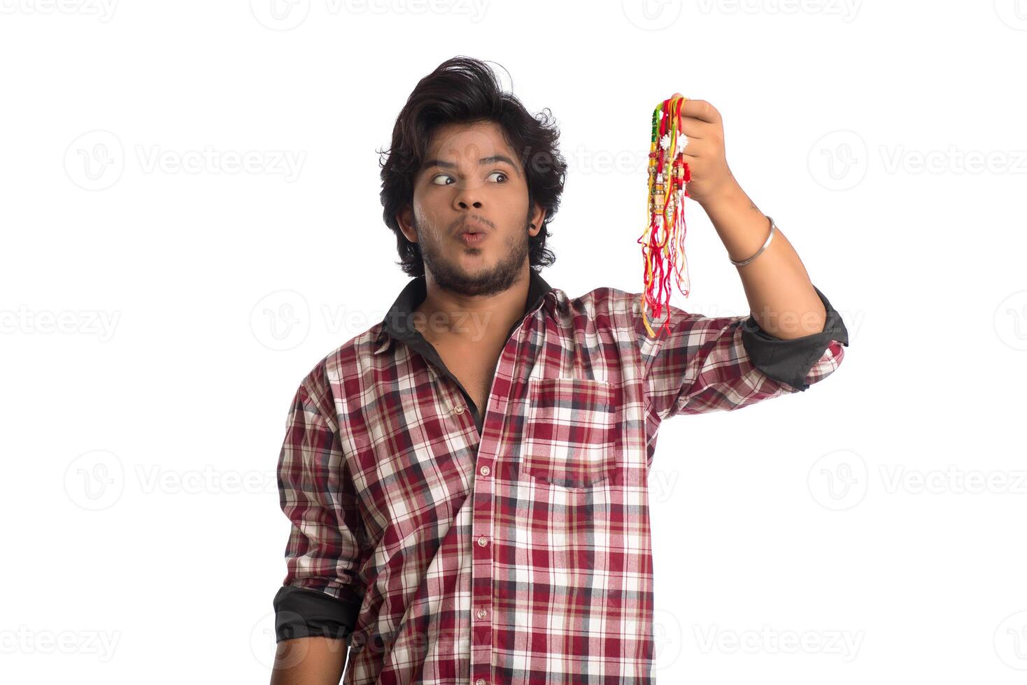 Young men showing rakhi in hand and giving expression on an occasion of Raksha Bandhan festival. photo