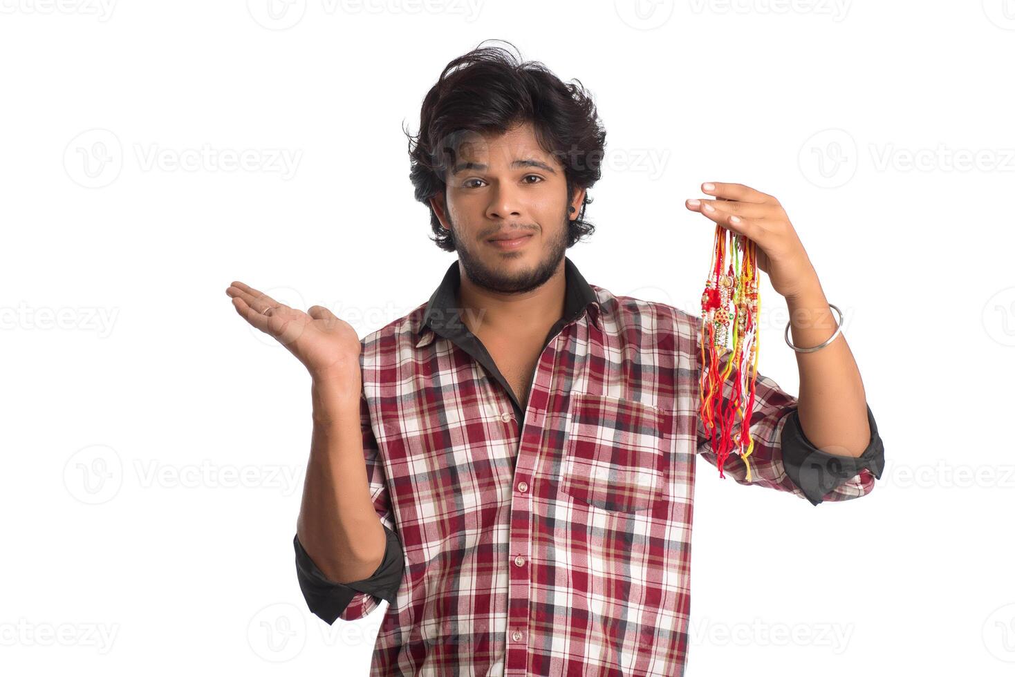Young men showing rakhi in hand and giving expression on an occasion of Raksha Bandhan festival. photo