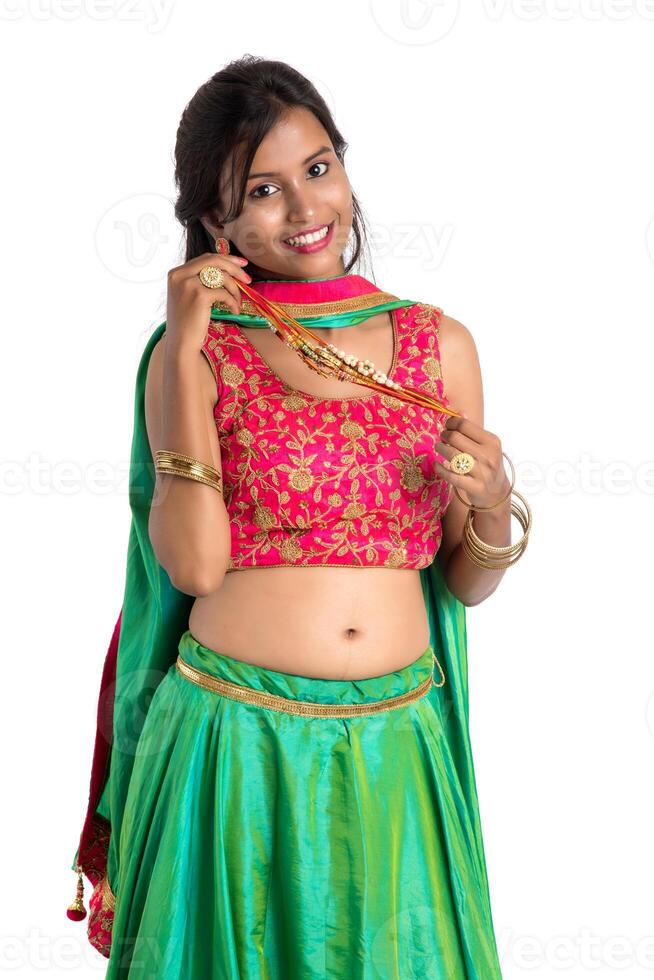 Beautiful girl showing Rakhi on occasion of Raksha bandhan on a white background. Sister tie Rakhi as symbol of intense love for her brother. photo