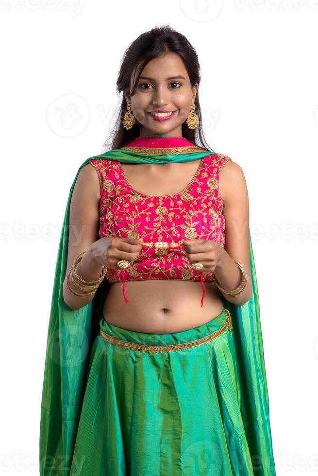 Beautiful girl showing Rakhi on occasion of Raksha bandhan on a white background. Sister tie Rakhi as symbol of intense love for her brother. photo
