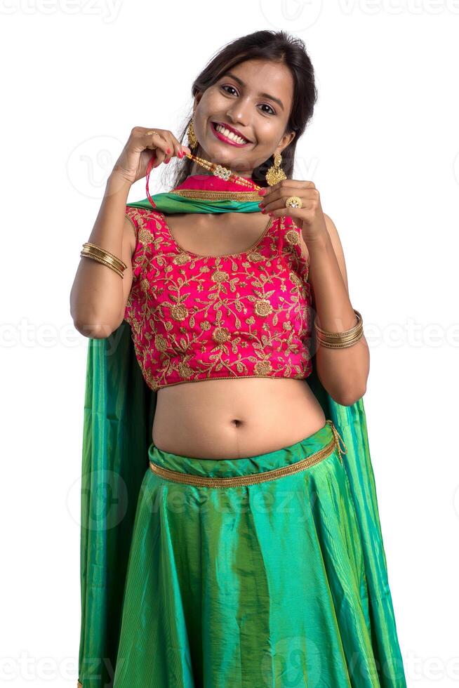 Beautiful girl showing Rakhi on occasion of Raksha bandhan on a white background. Sister tie Rakhi as symbol of intense love for her brother. photo