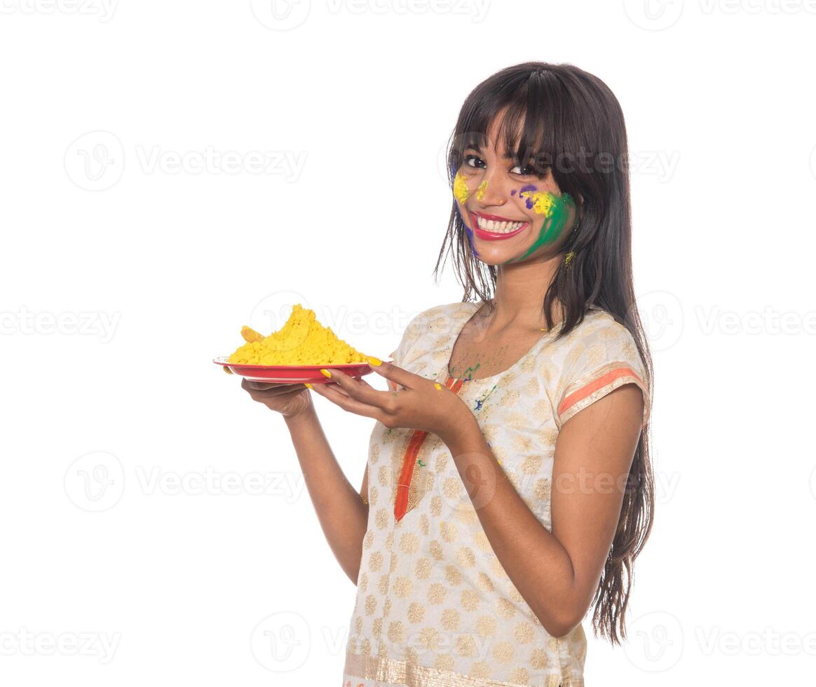 Beautiful young girl holding powdered color in plate on the occasion of Holi festival. photo