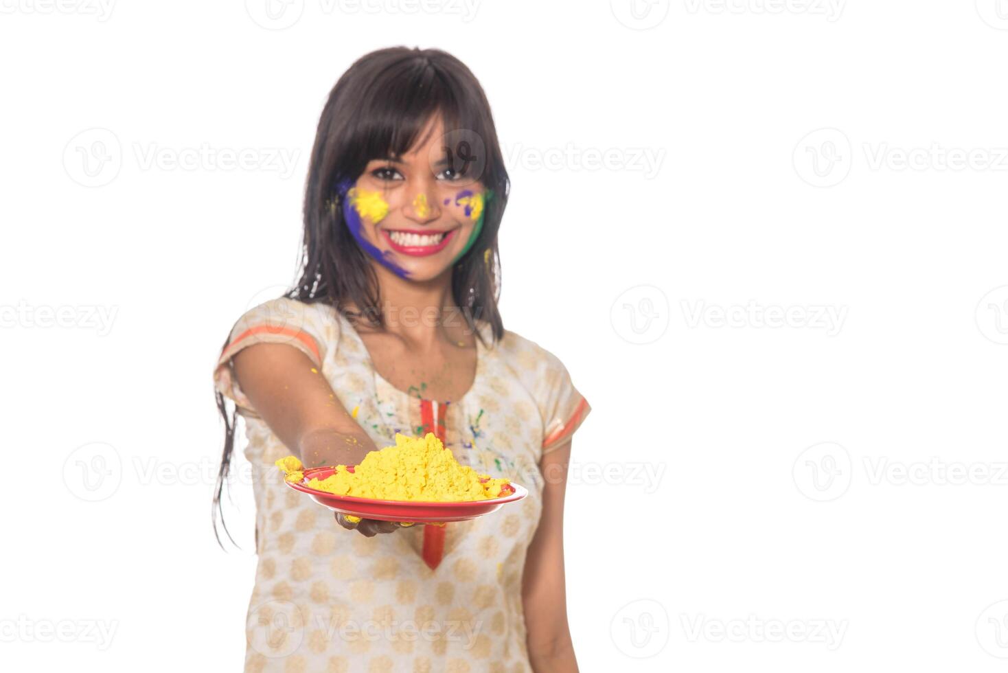 Beautiful young girl holding powdered color in plate on the occasion of Holi festival. photo