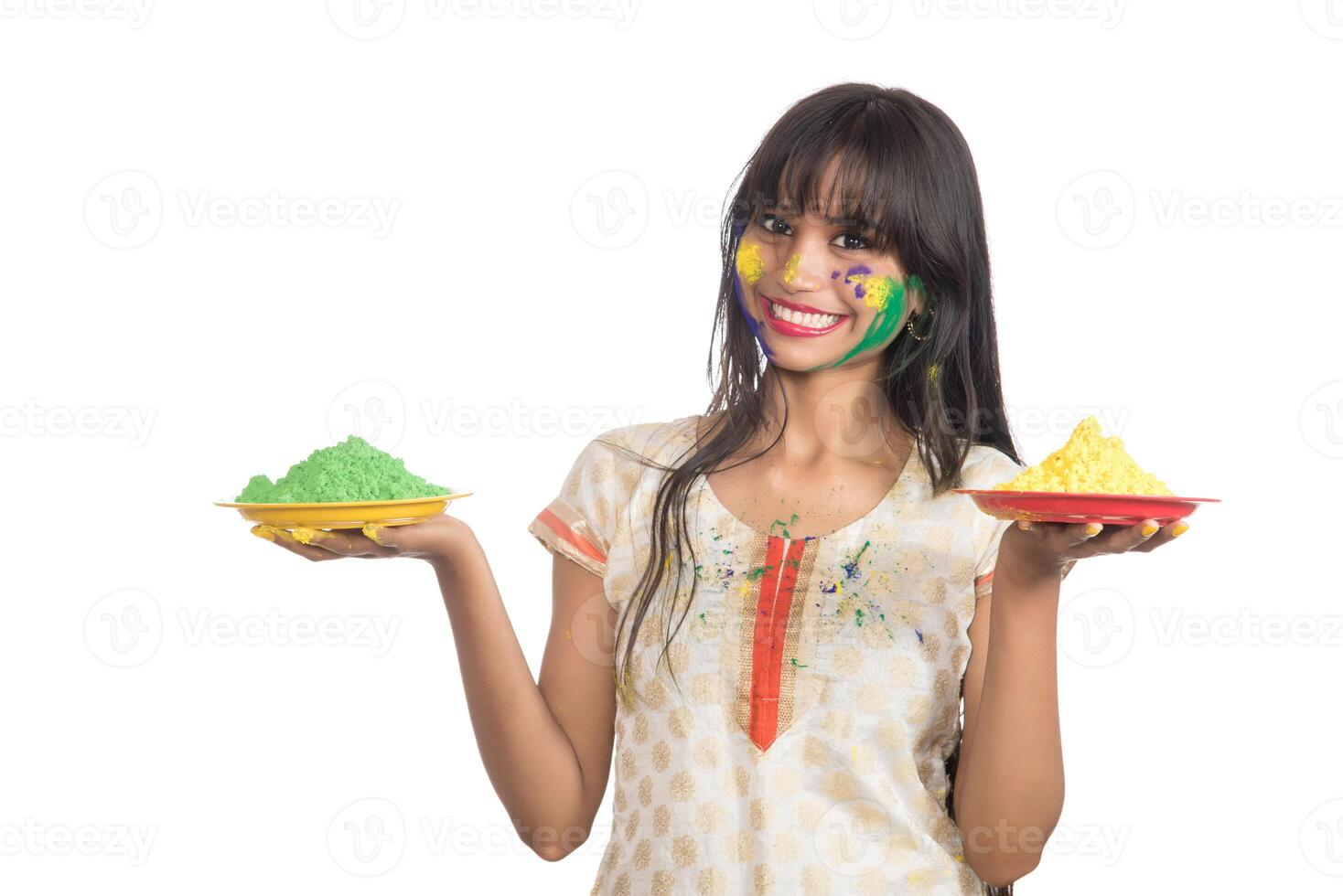 Beautiful young girl holding powdered color in plate on the occasion of Holi festival. photo