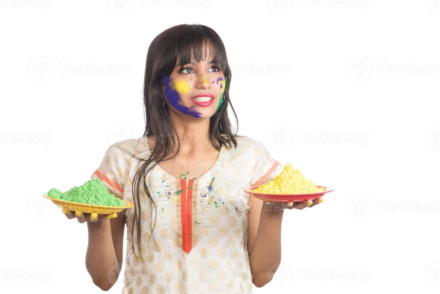 Beautiful young girl holding powdered color in plate on the occasion of Holi festival. photo