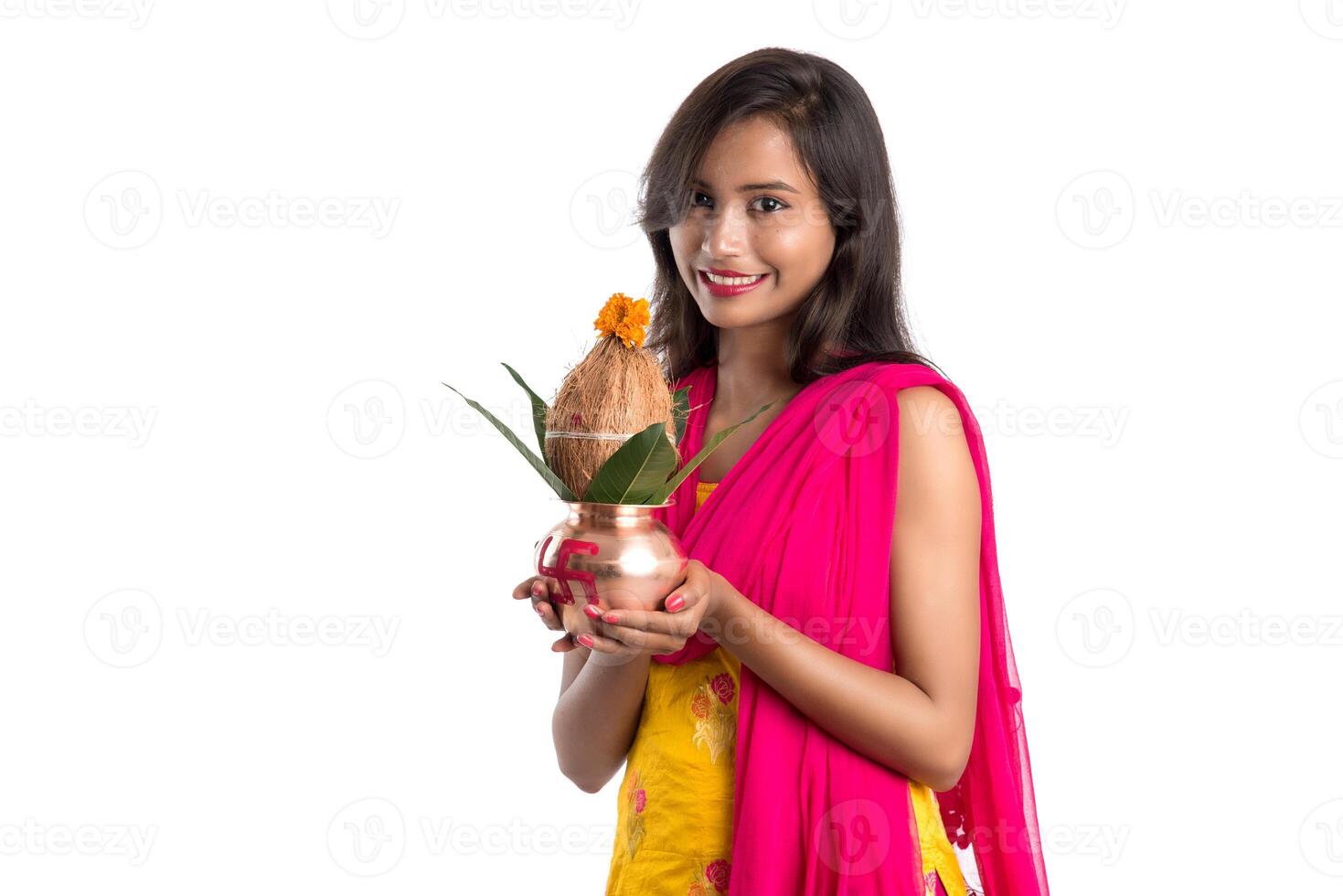 Indian girl holding a traditional copper Kalash, Indian Festival, copper Kalash with coconut and mango leaf with floral decoration, essential in Hindu Pooja. photo