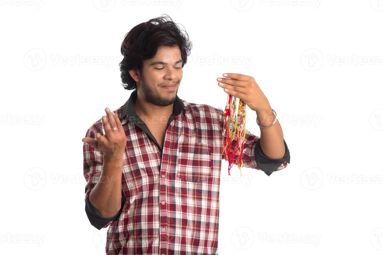 Young men showing rakhi in hand and giving expression on an occasion of Raksha Bandhan festival. photo