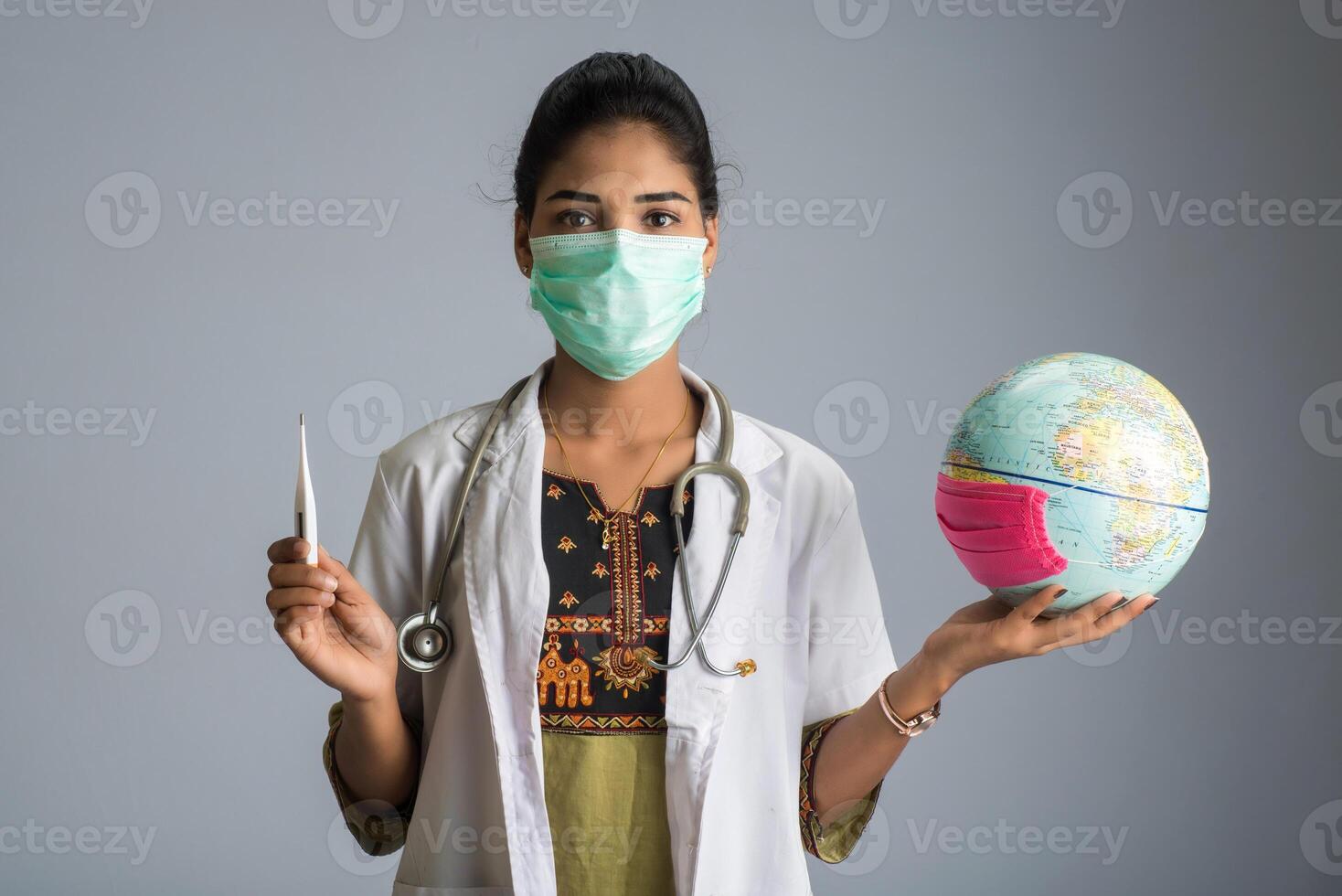 woman doctor holding Earth globe for presenting virus pandemic outbreak on the whole planet. Global warming and temperature rising presentation. photo