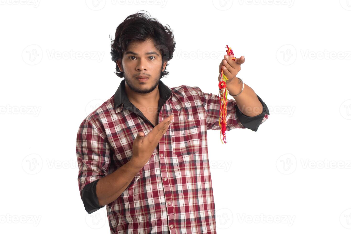 Young men showing rakhi in hand and giving expression on an occasion of Raksha Bandhan festival. photo