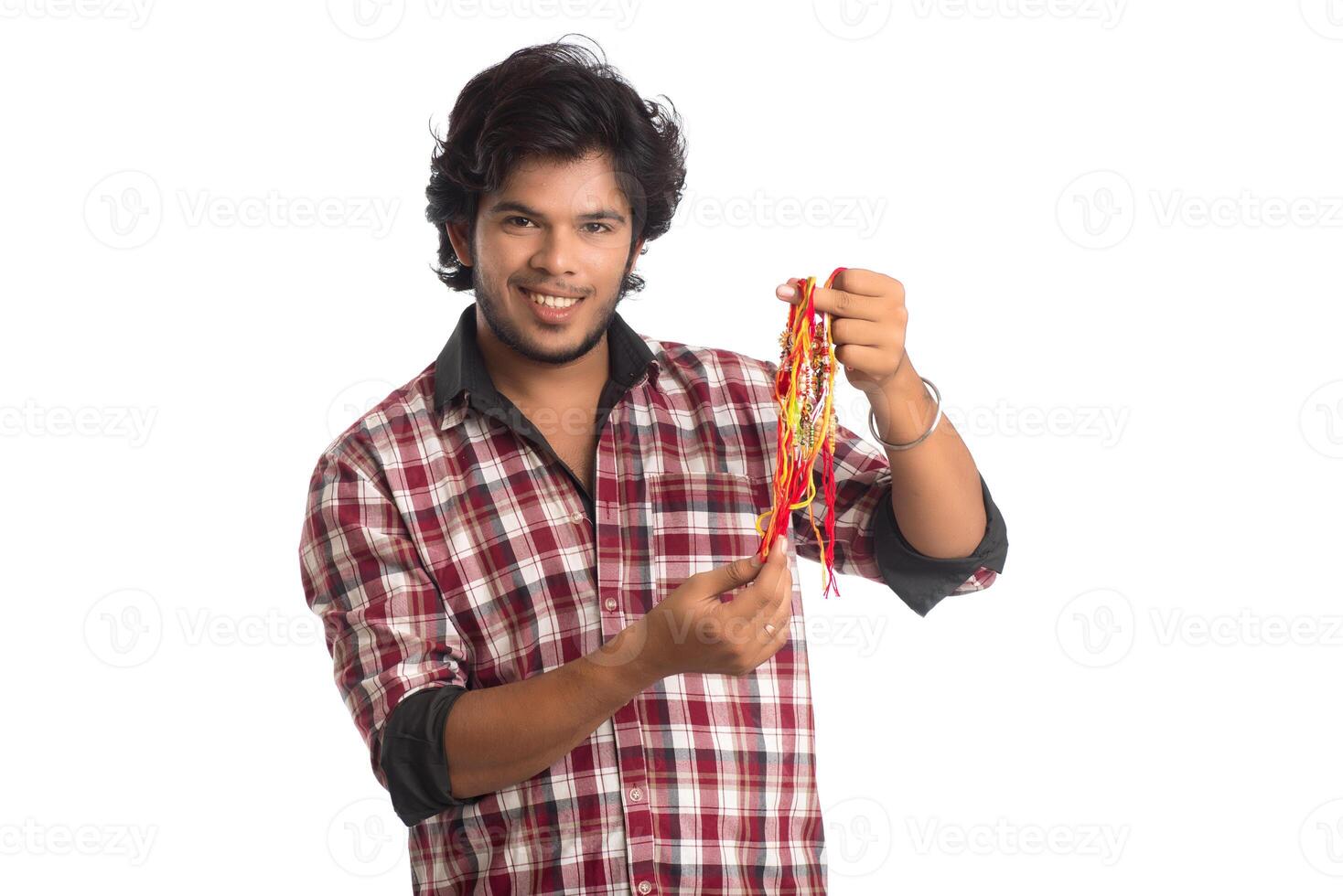 Young men showing rakhi in hand and giving expression on an occasion of Raksha Bandhan festival. photo