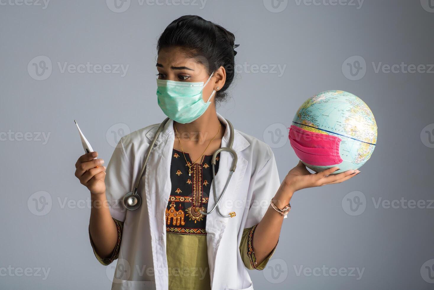 woman doctor holding Earth globe for presenting virus pandemic outbreak on the whole planet. Global warming and temperature rising presentation. photo