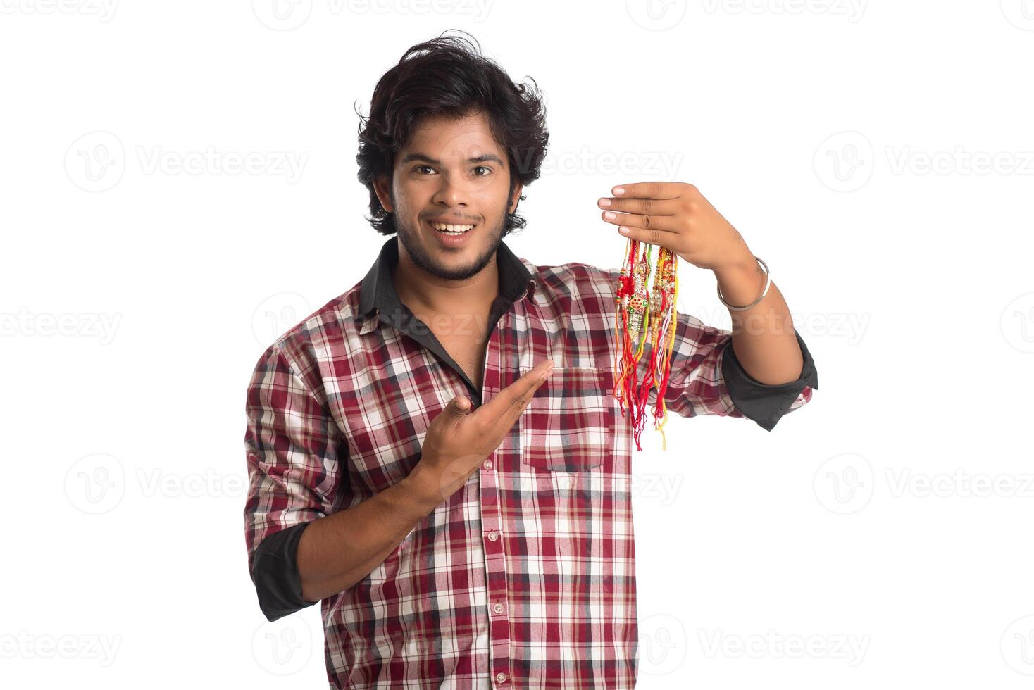 Young men showing rakhi in hand and giving expression on an occasion of Raksha Bandhan festival. photo