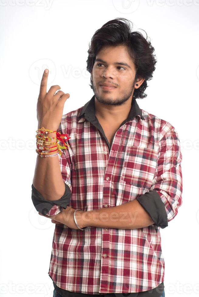 Young men showing rakhi on his hand on an occasion of Raksha Bandhan festival. photo