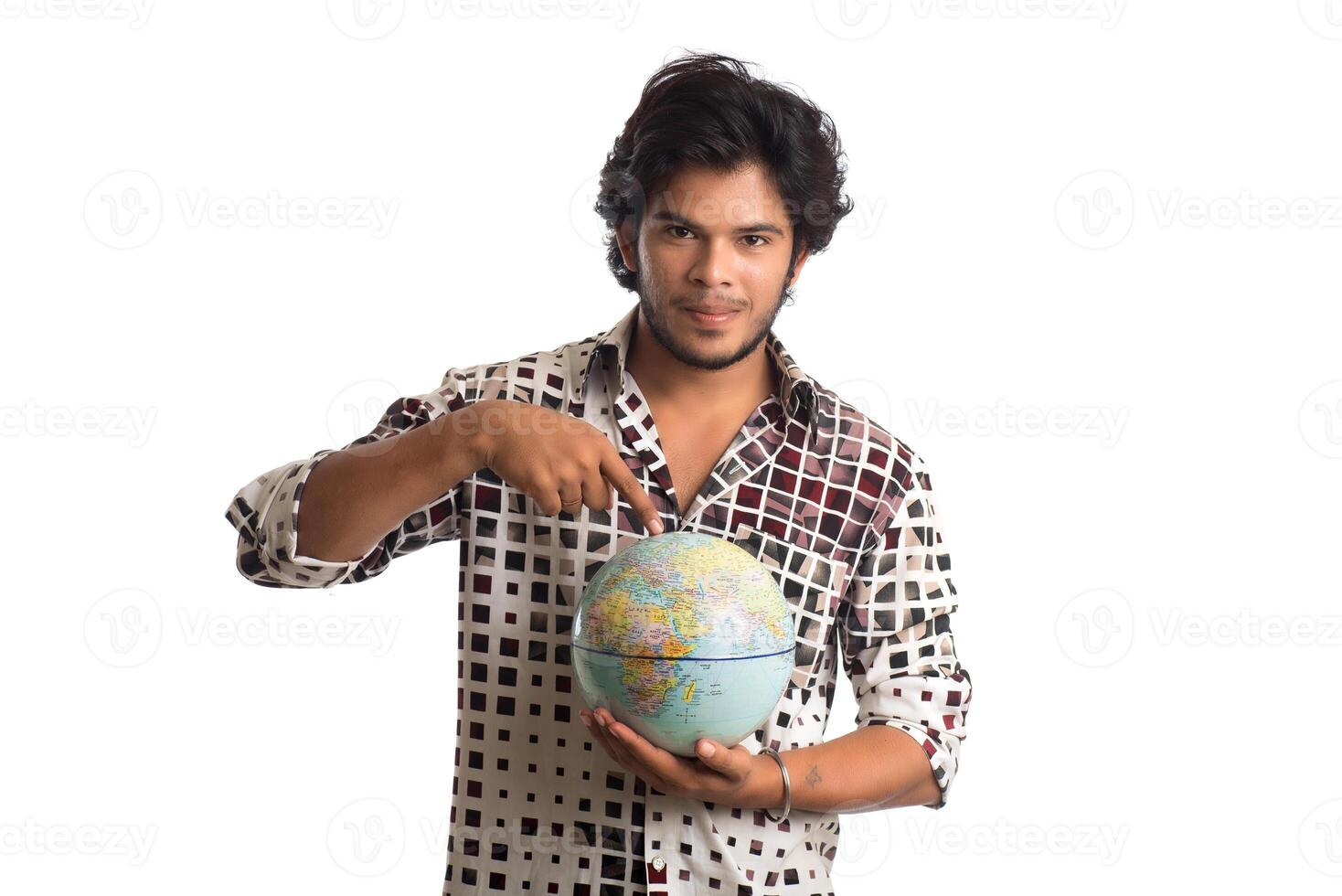young man with a world globe on a white background. photo