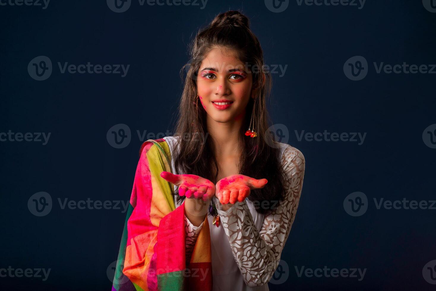 A beautiful young girl plays with colors on the occasion of Holi. The concept for the Indian festival Holi photo