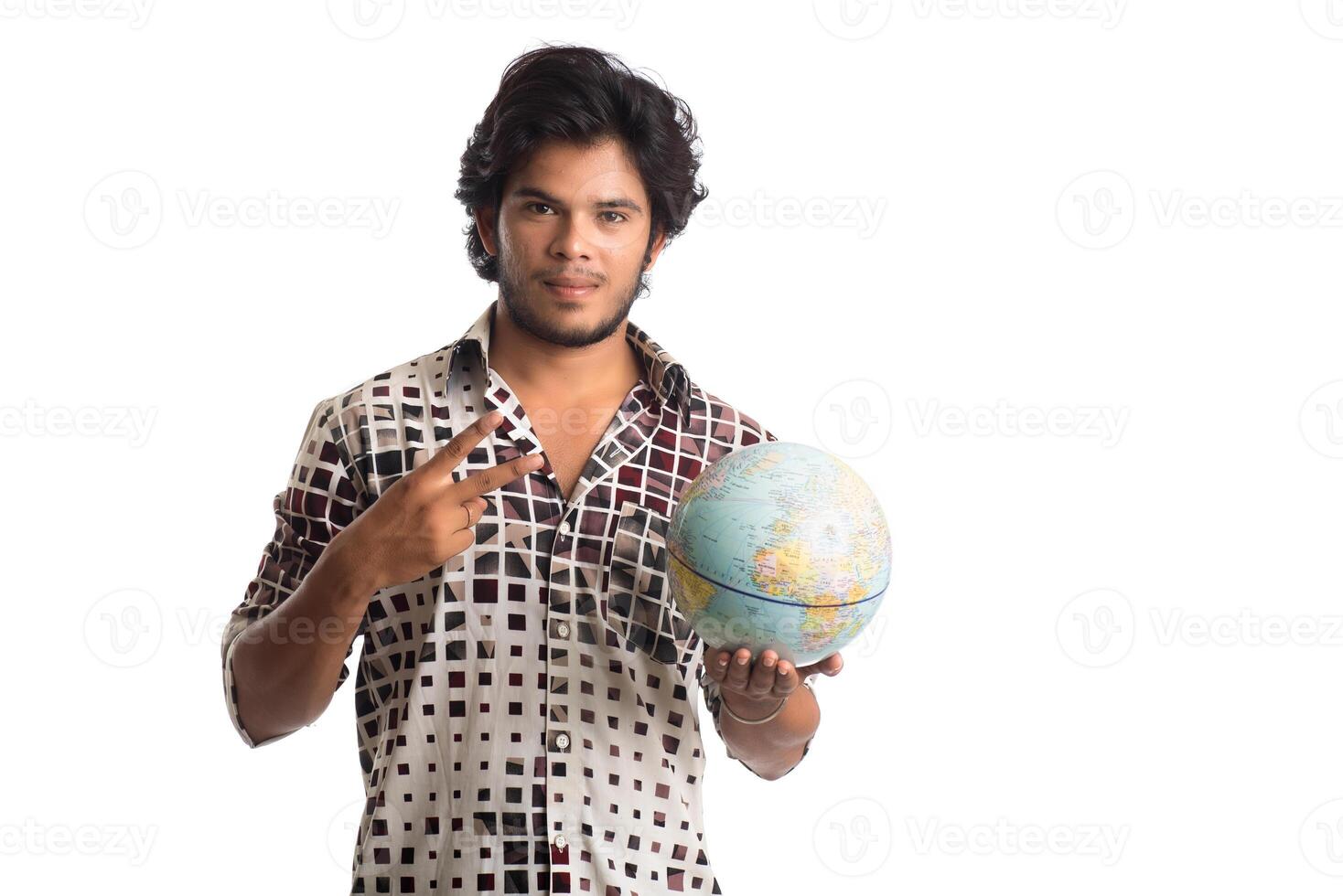 young man with a world globe on a white background. photo