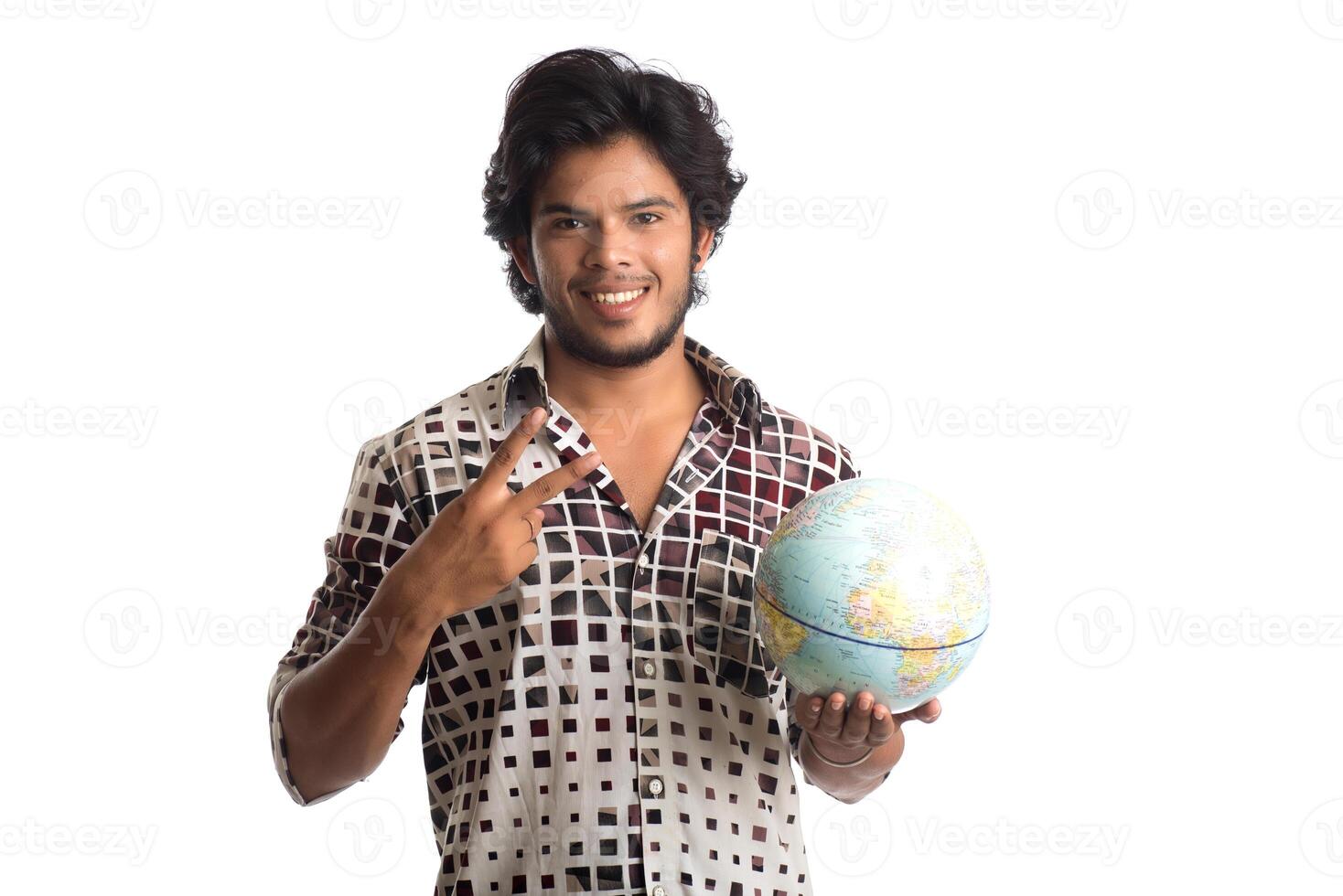 young man with a world globe on a white background. photo
