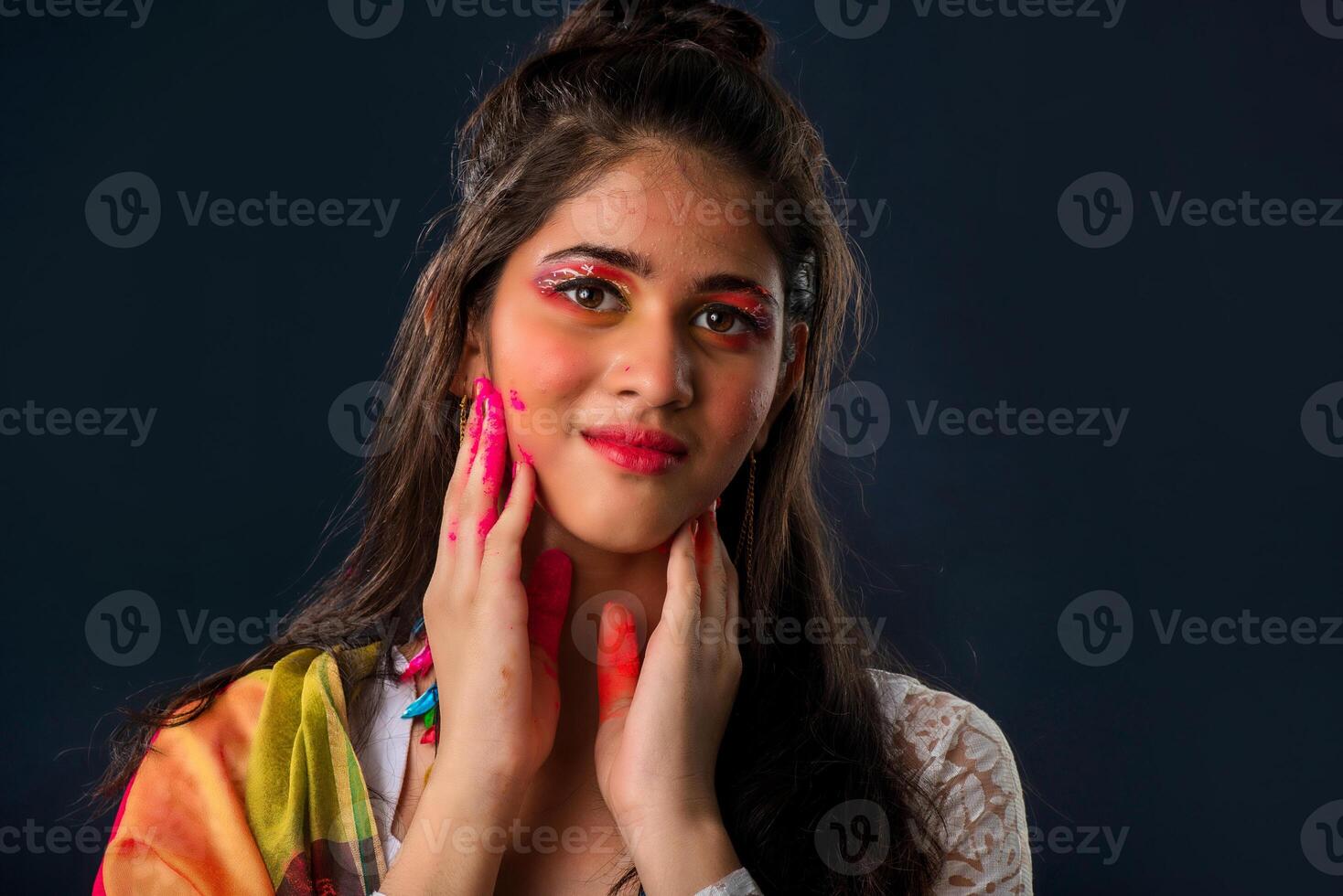 A beautiful young girl plays with colors on the occasion of Holi. The concept for the Indian festival Holi photo
