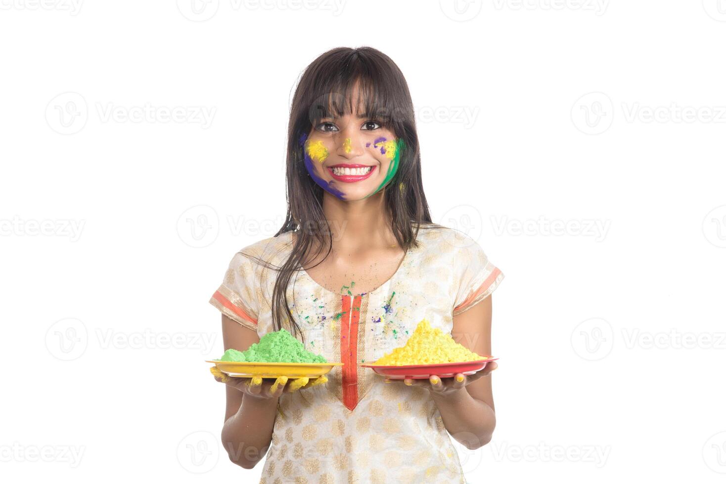 Beautiful young girl holding powdered color in plate on the occasion of Holi festival. photo