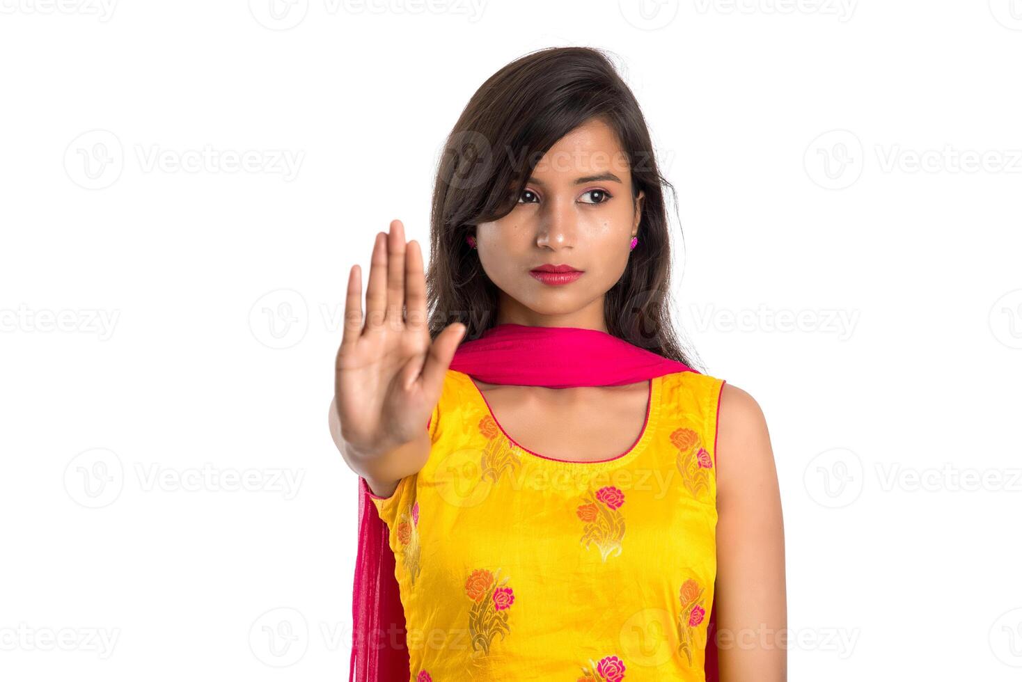 Portrait of a beautiful girl showing stop sign with palms isolated on a white background photo