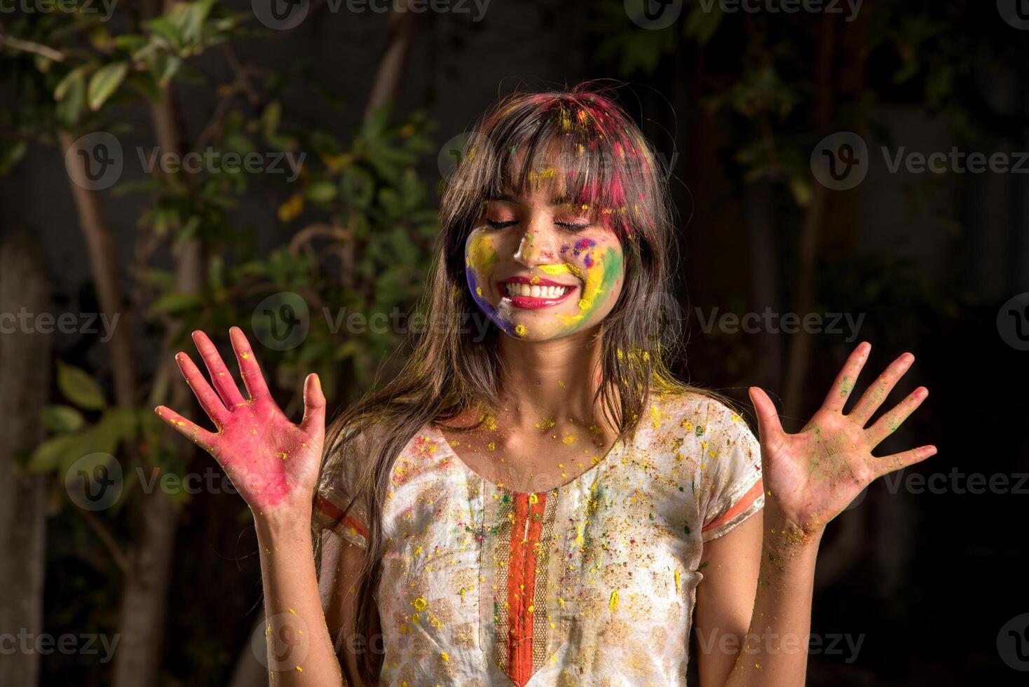 Portrait of a happy young girl on the festival of colors Holi. Girl posing and celebrating the festival of colors. photo