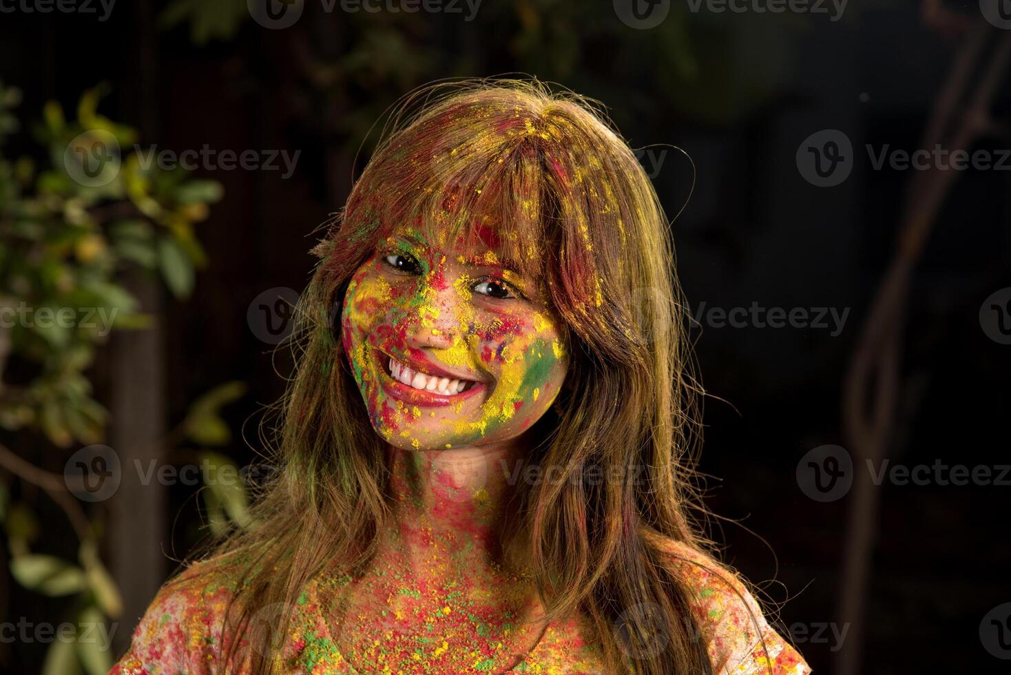 Portrait of a happy young girl on the festival of colors Holi. Girl posing and celebrating the festival of colors. photo