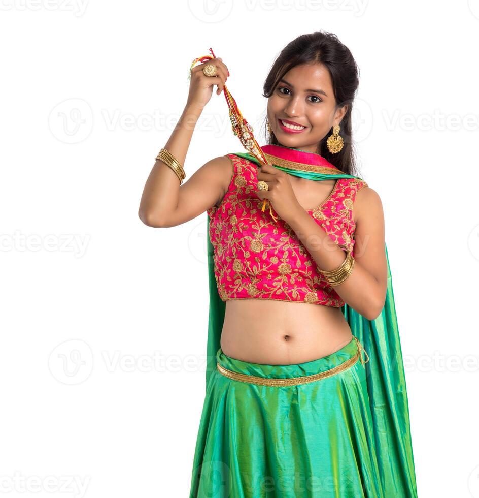 Beautiful girl showing Rakhi on occasion of Raksha bandhan on a white background. Sister tie Rakhi as symbol of intense love for her brother. photo