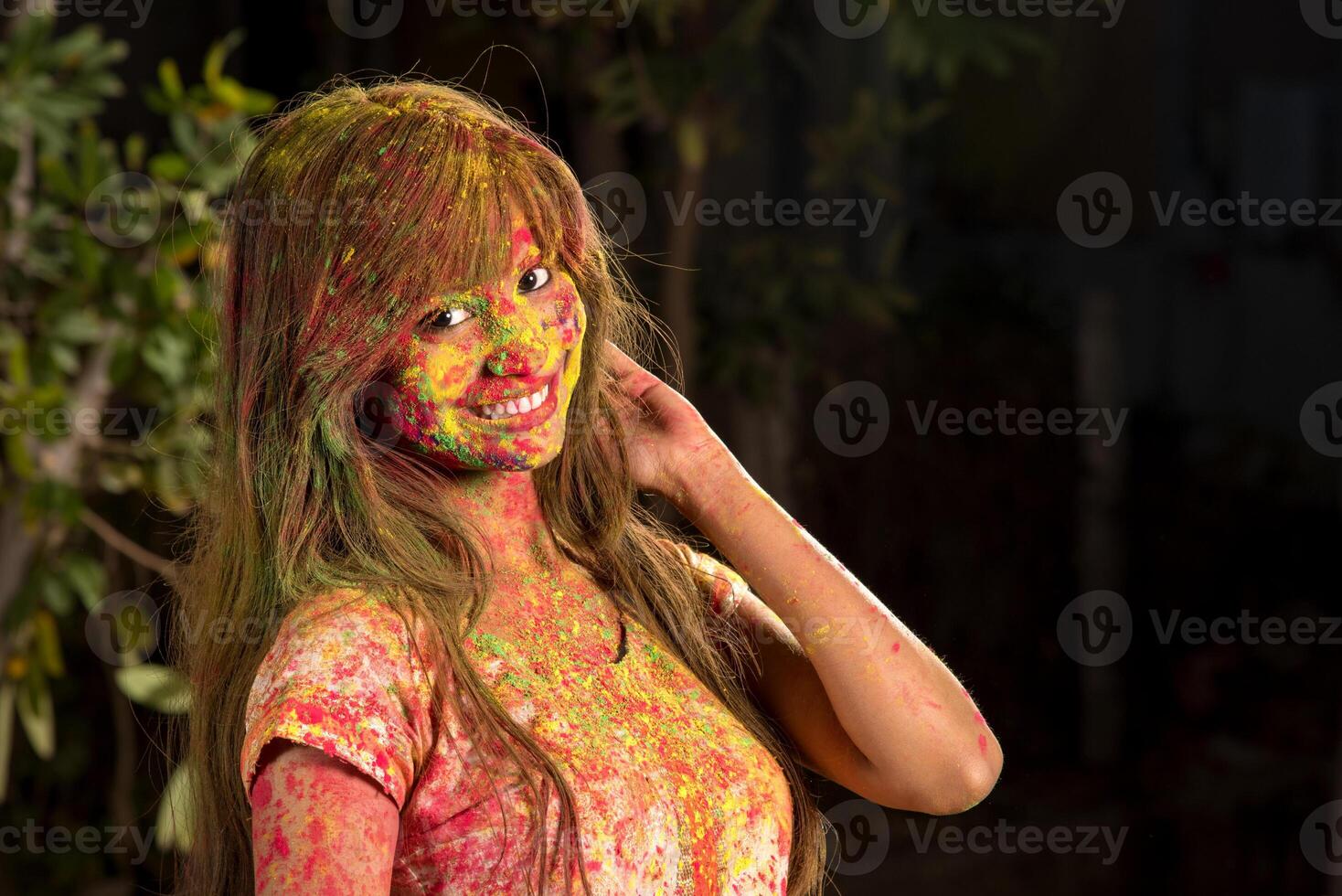 Portrait of a happy young girl on the festival of colors Holi. Girl posing and celebrating the festival of colors. photo