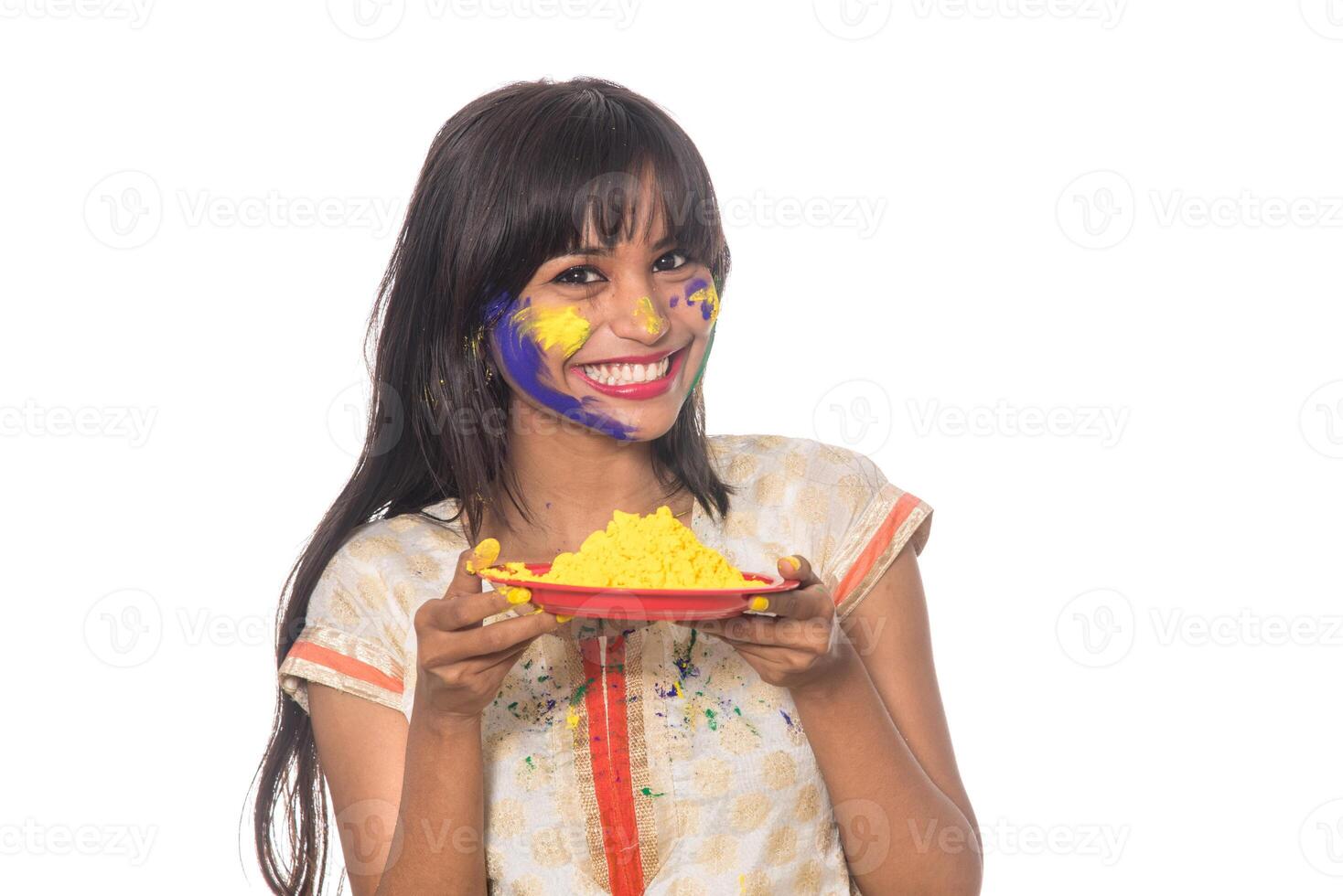 Beautiful young girl holding powdered color in plate on the occasion of Holi festival. photo