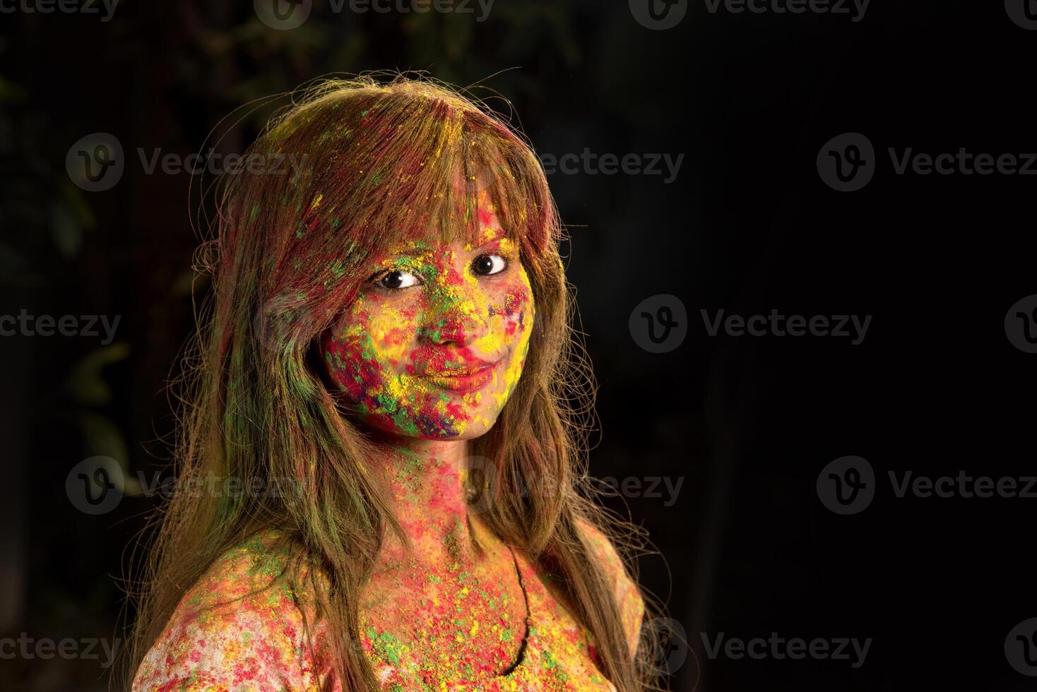 Portrait of a happy young girl on the festival of colors Holi. Girl posing and celebrating the festival of colors. photo