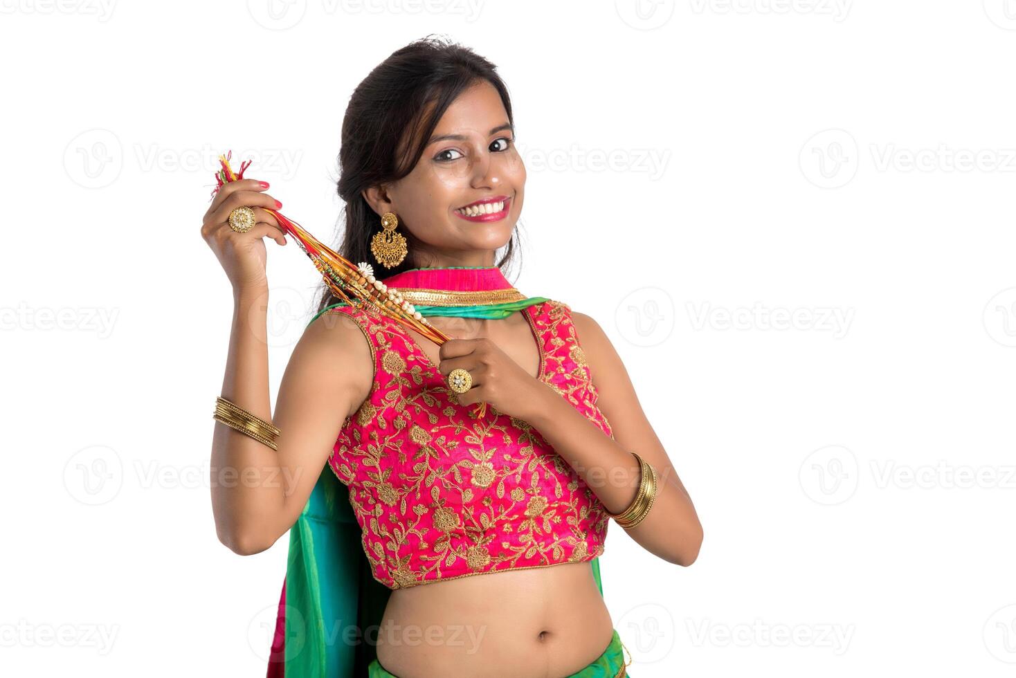 Beautiful girl showing Rakhi on occasion of Raksha bandhan on a white background. Sister tie Rakhi as symbol of intense love for her brother. photo
