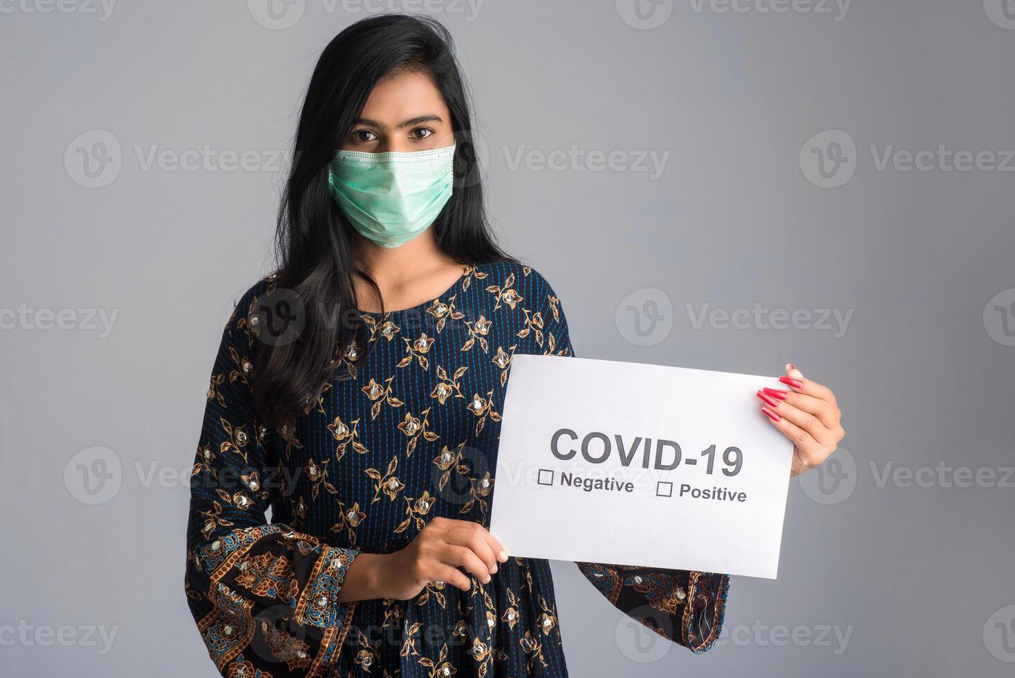 A young woman in a medical mask holding a board of the epidemic of Coronavirus, Covid-19 photo