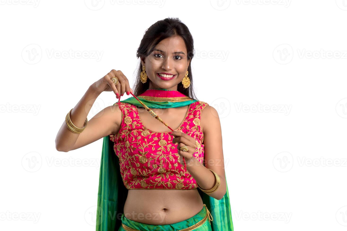 Beautiful girl showing Rakhi on occasion of Raksha bandhan on a white background. Sister tie Rakhi as symbol of intense love for her brother. photo