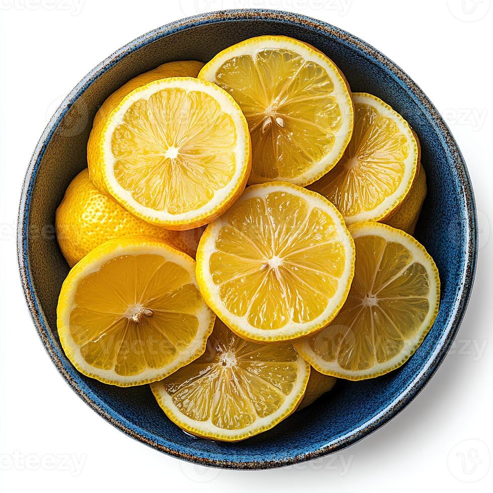 lemon fruit bowl isolated on white background with shadow. lemons in bowl top view. organic, healthy, vegan and vegetarian lemon fruit slices flat lay photo