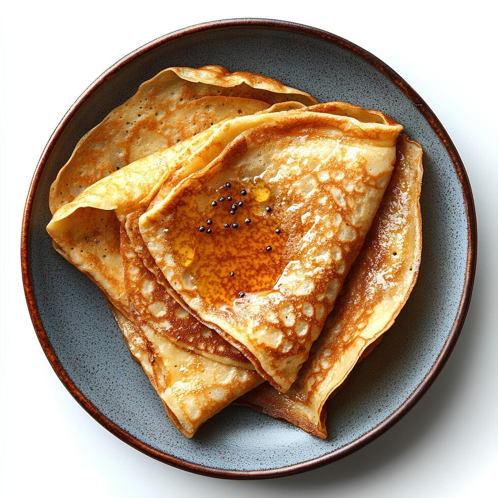 apricot jam crepe on plate top view isolated on white background with shadow. marmalade pancake dessert on ceramic plate photo