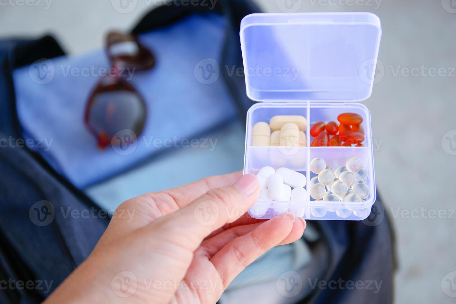 Clothes and pills in a travel bag. Concept of medication required in journey. photo