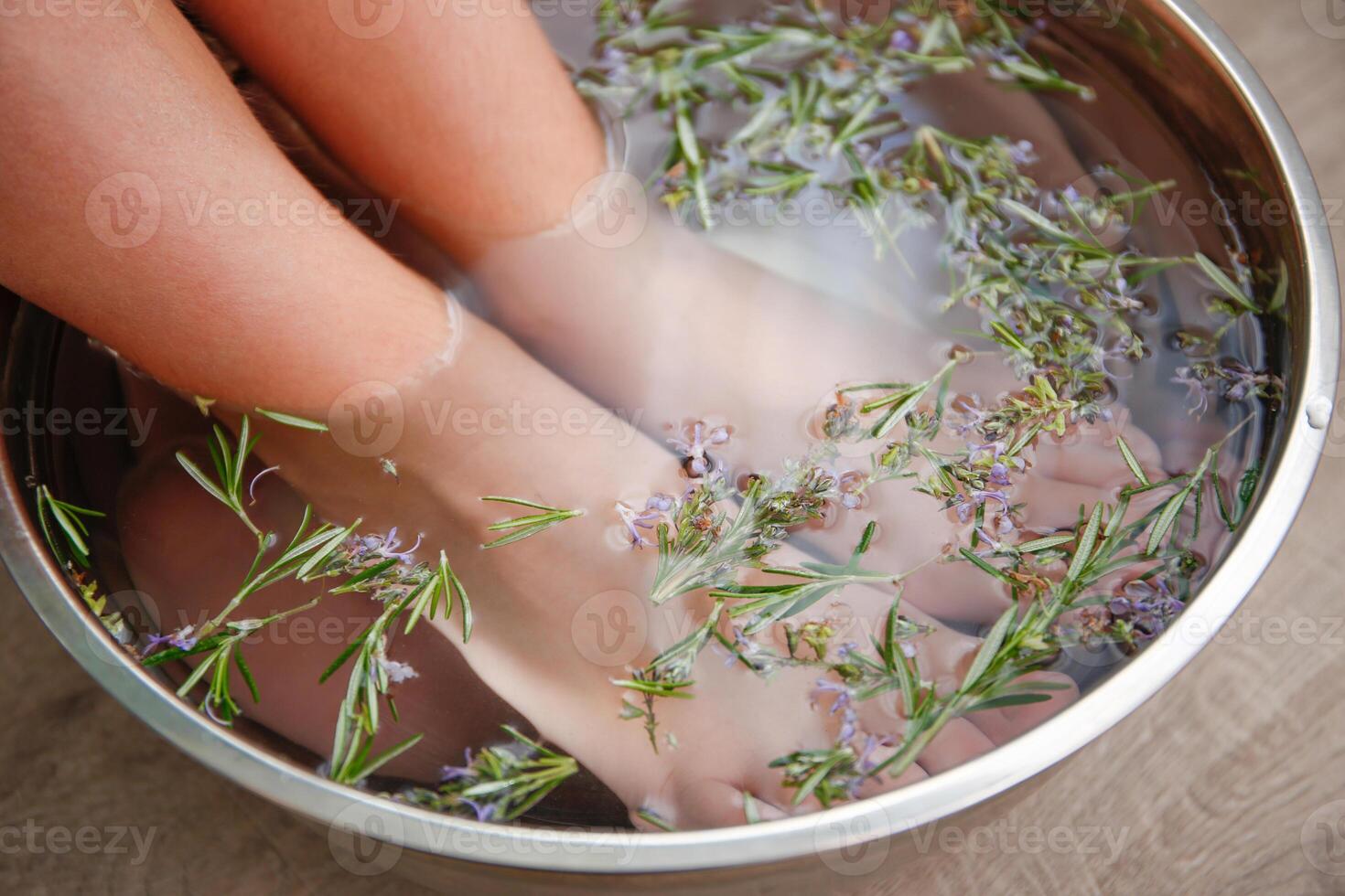 Foot baths with rosemary leaves photo