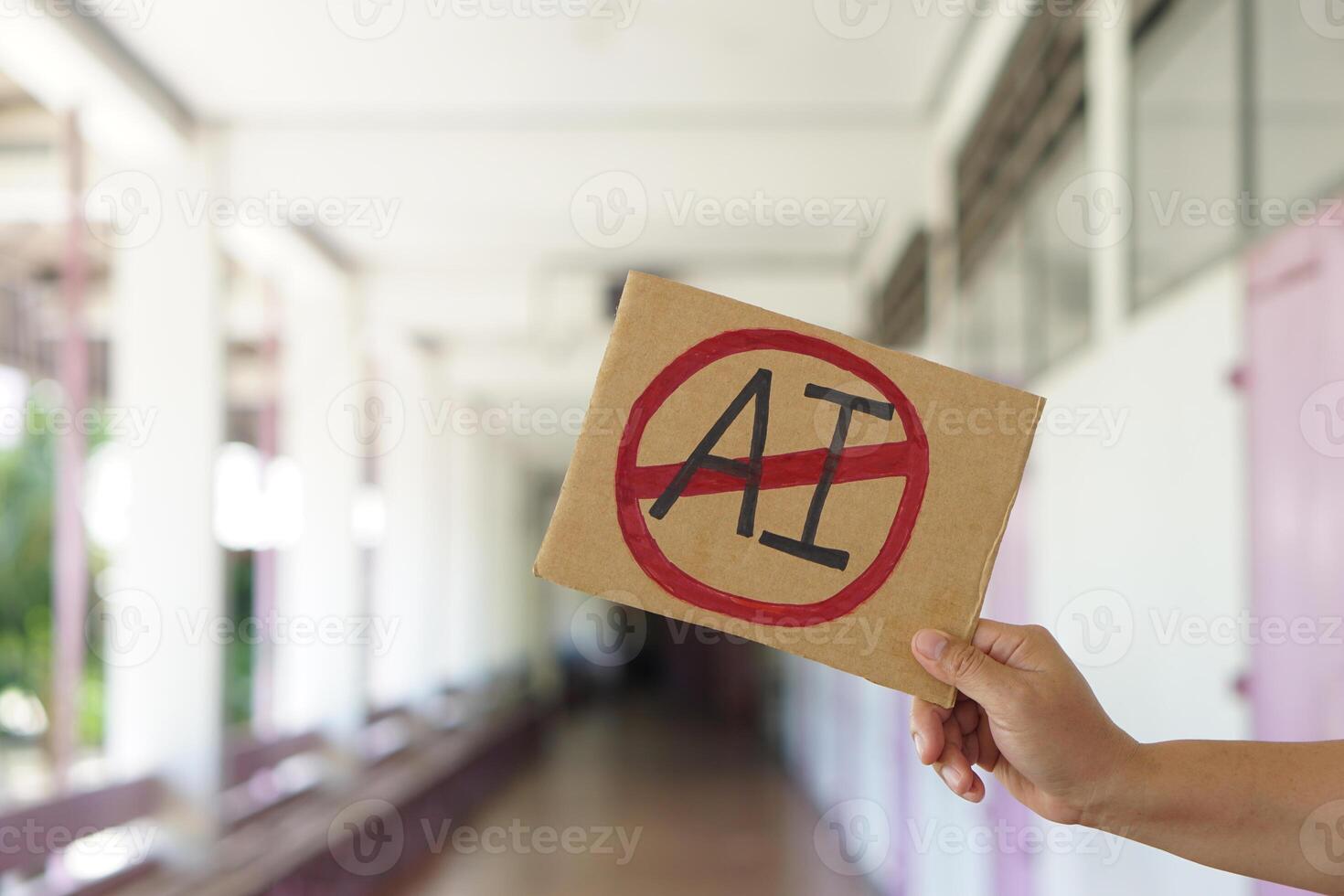 Close up hand holds paper card with No AI, prohibition sign, outdoor nature background. Concept, disagree, anti or don't support to use AI or Artificial Intelligence in daily life. photo