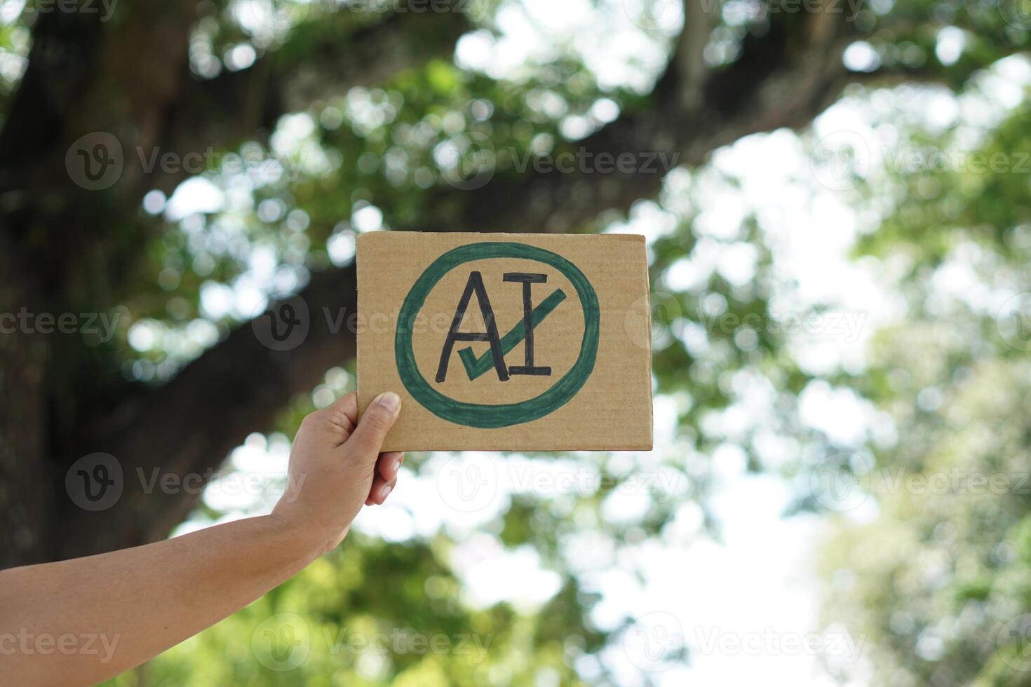 Close up hand holds paper card with drawn sign AI in circle and tick mark. Concept, Choose ,agree and accept to use AI or Artificial Intelligence to apply in daily life. photo