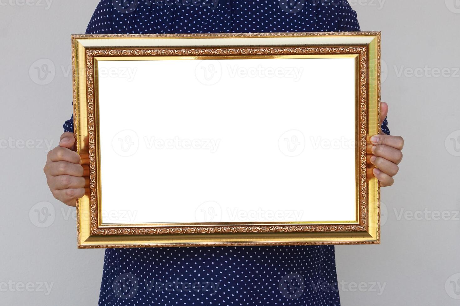 Closeup woman holds empty photo frame or blank diploma certificate frame. Copy space for adding text or photos. Concept, Proud, memories and nostalgia .