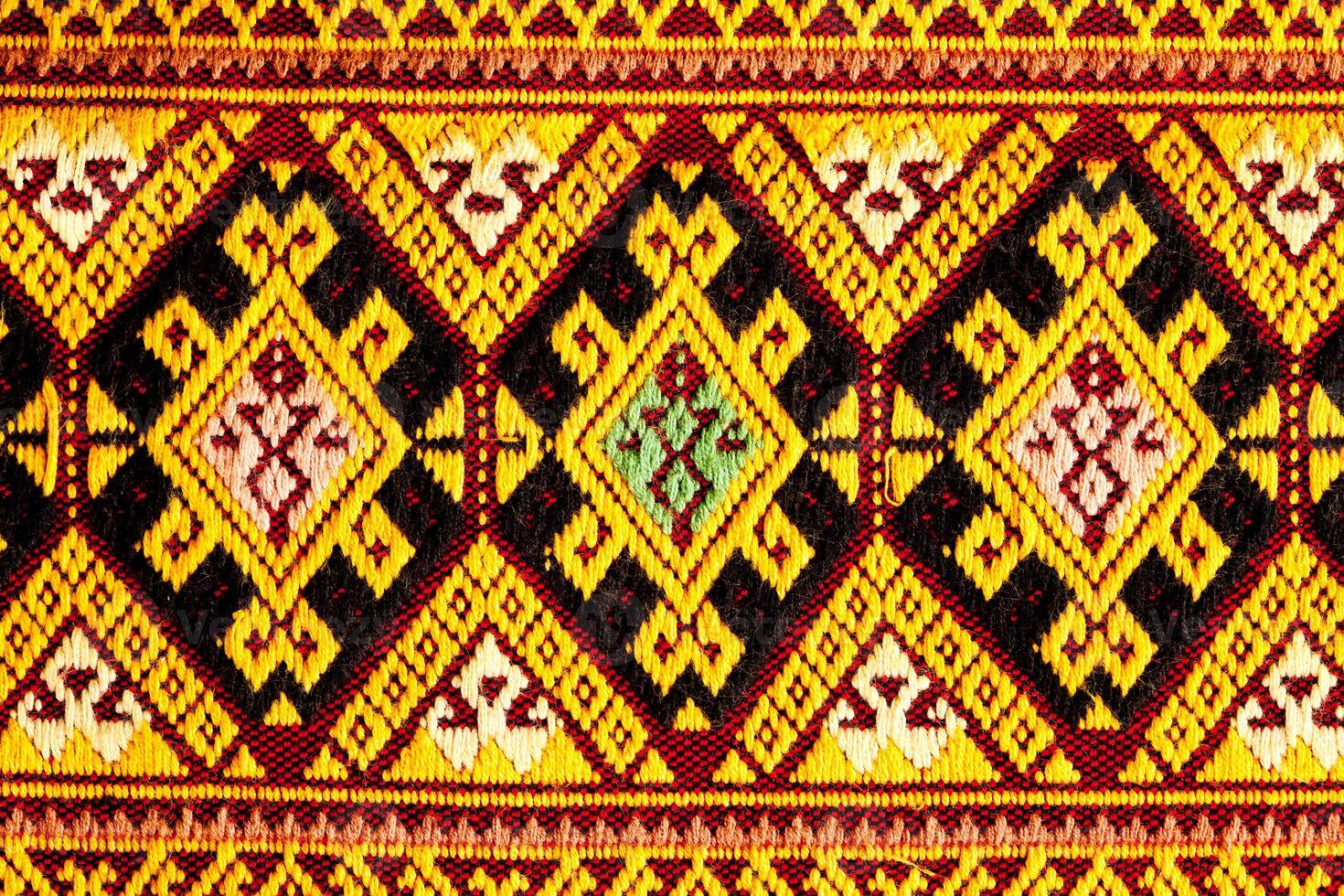 Closeup view pattern of beautiful ancient Thai woven cloth. photo
