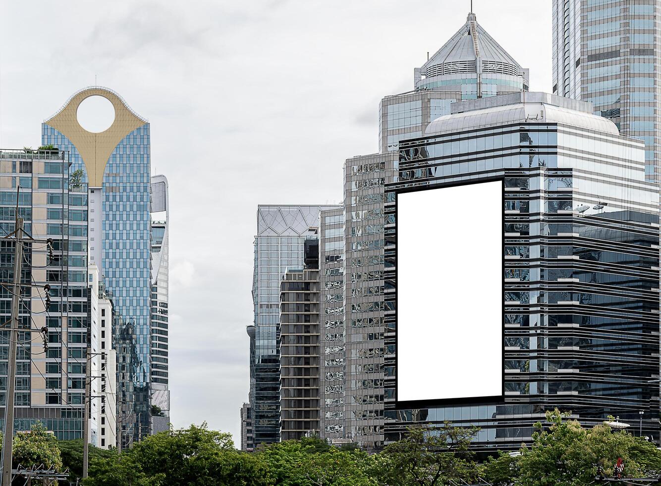 Mock up white vertical large LED display billboard on tower building with cityscape background .Clipping path for mockup photo
