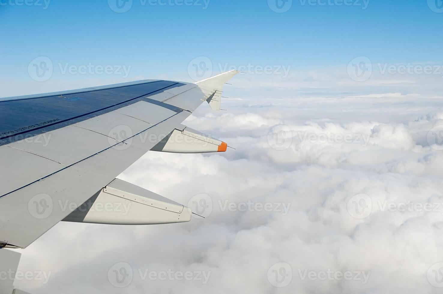 Above clouds in a plane photo